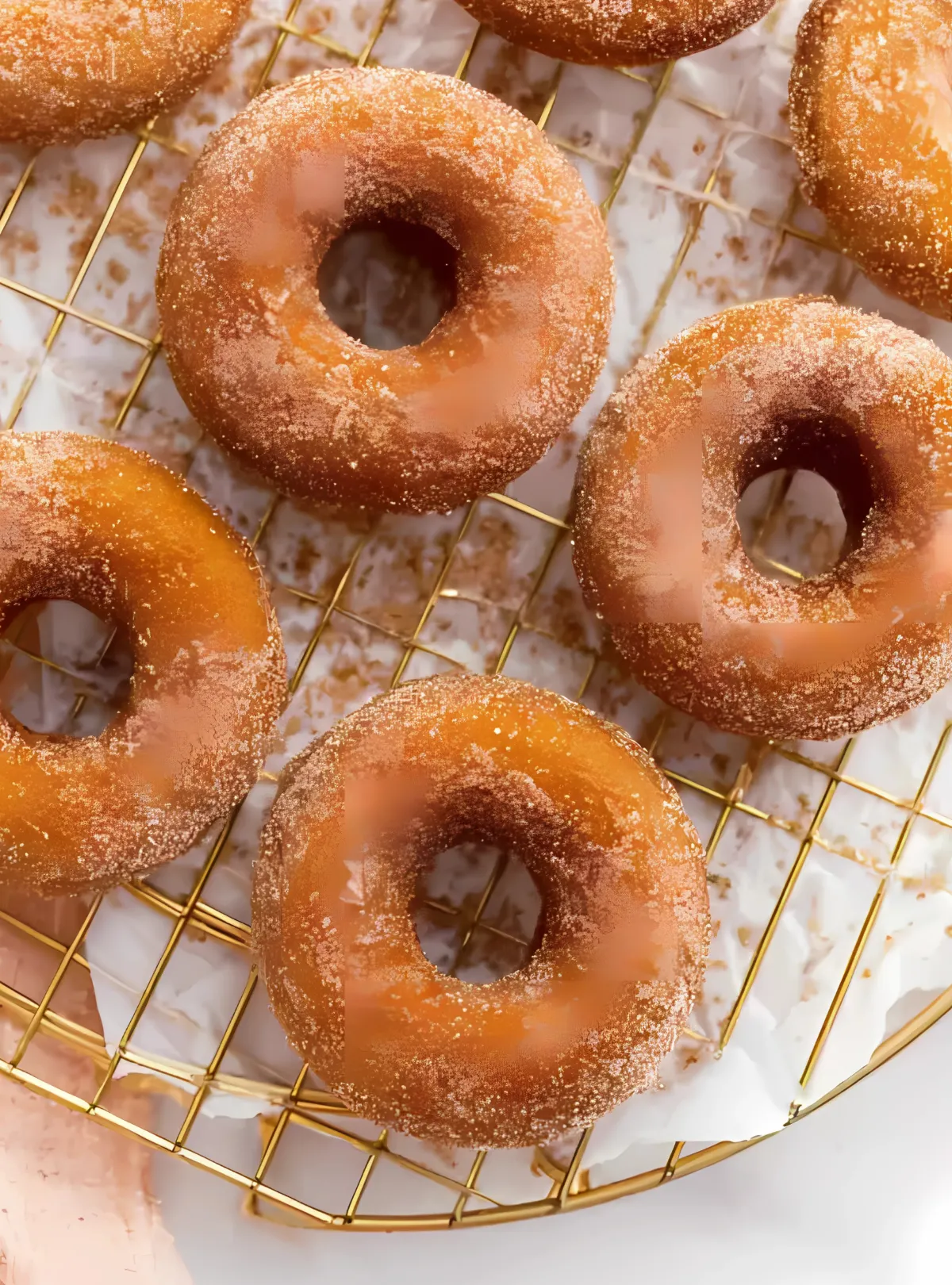 Freshly baked donuts cooling on wire rack