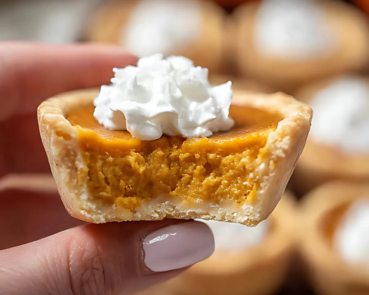Hand holding pumpkin pie bite