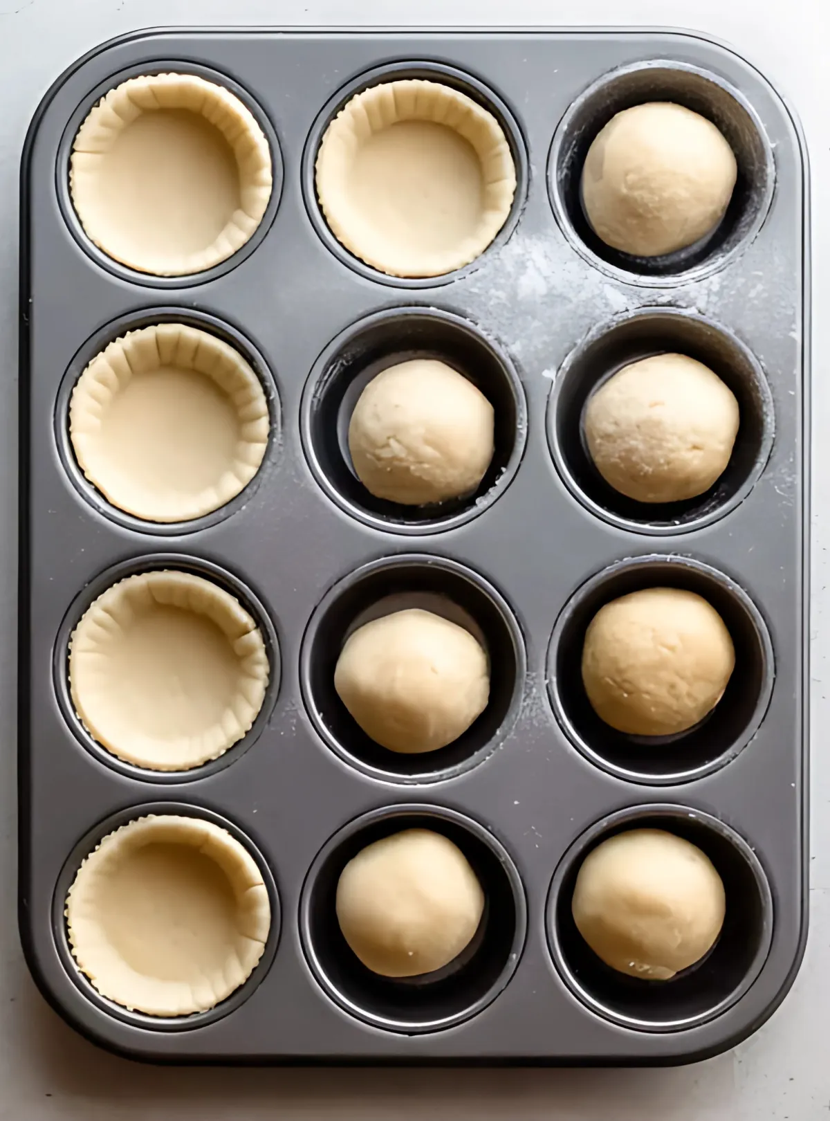 Muffin tin with dough balls