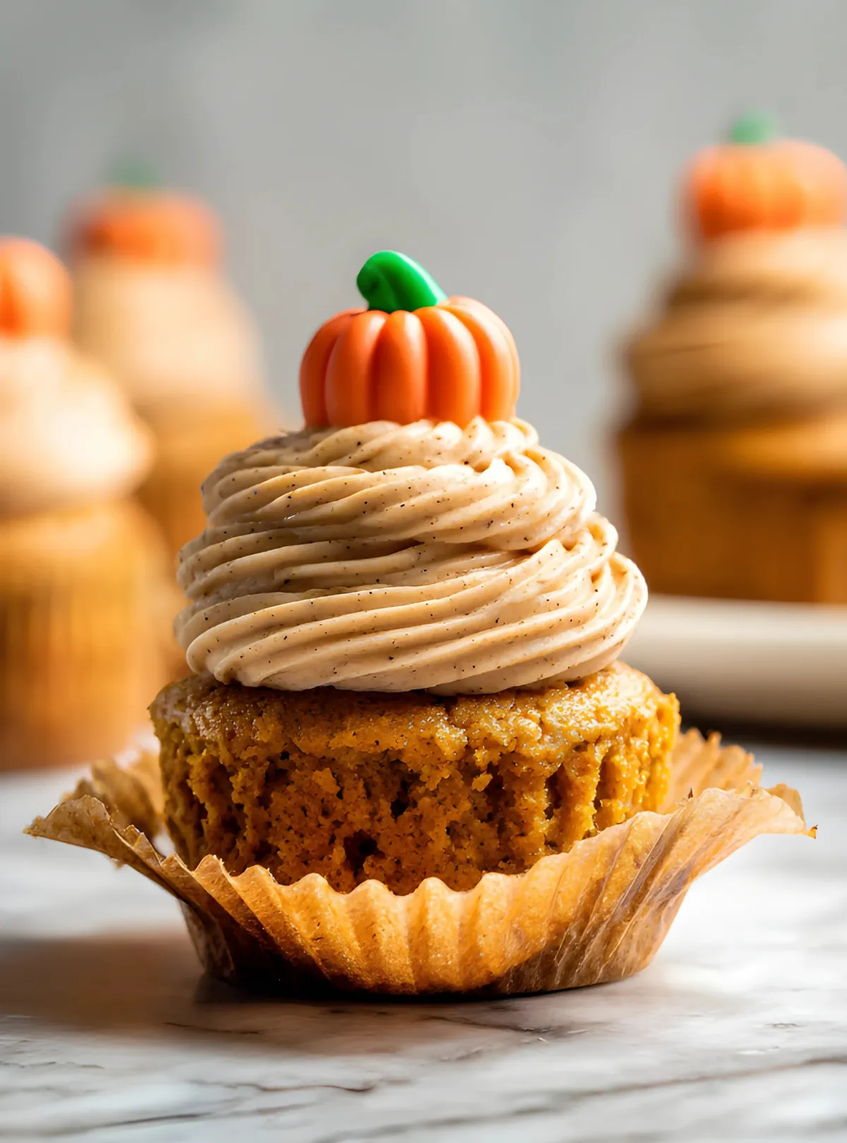 Pumpkin cupcake with unwrapped liner showing texture
