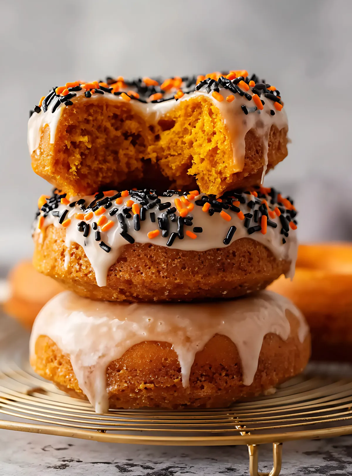 Pumpkin donut stack with orange and black sprinkles glaze