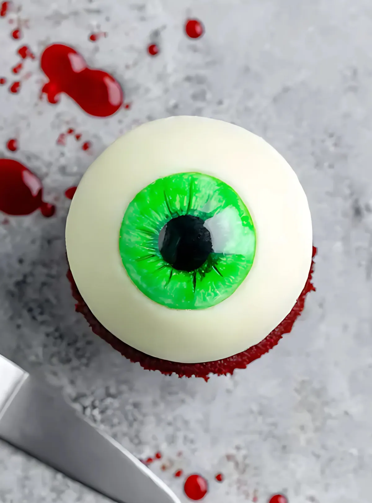 Single eyeball cupcake with green iris and red blood vessel details