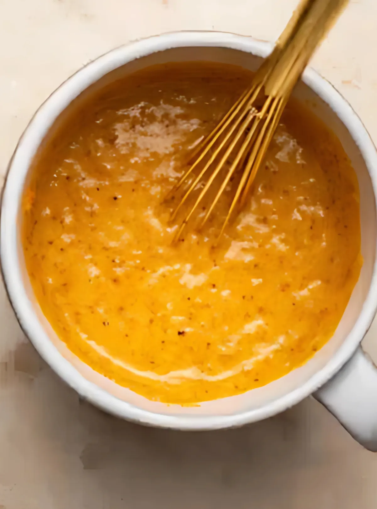 whisking pumpkin batter mug