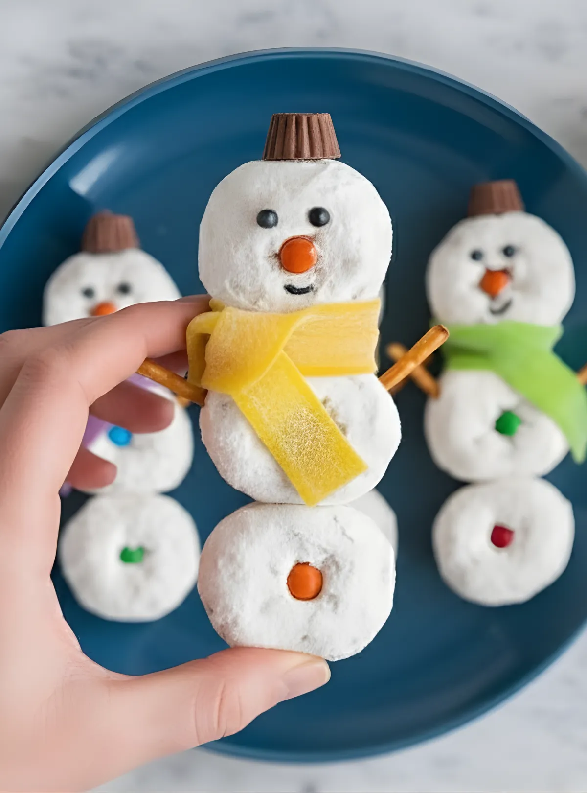 Hand holding snowman