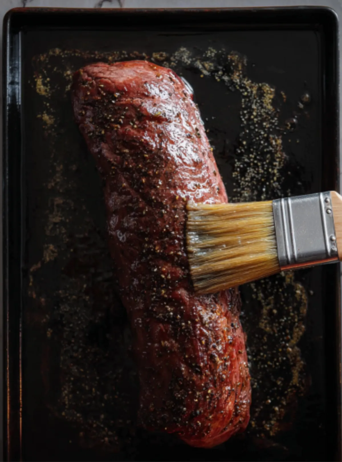 brushing seasoned beef tenderloin