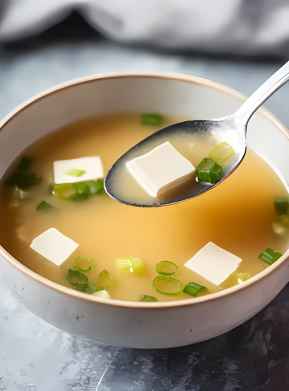 Spoon lifting tofu cube